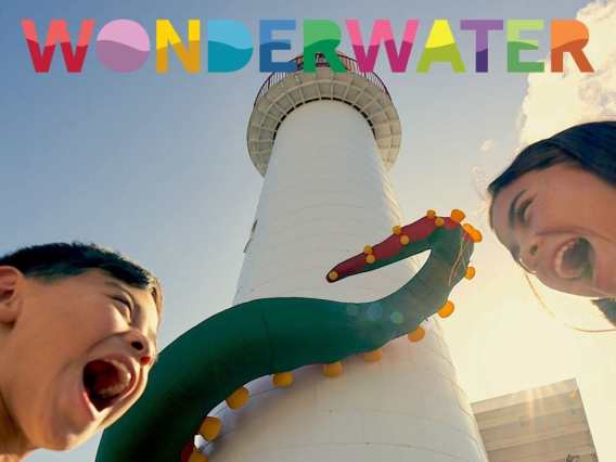 Wonderwater logo overlaid on image of two children's faces looking excited in front of a lighthouse surrounded by an octopus tentacle